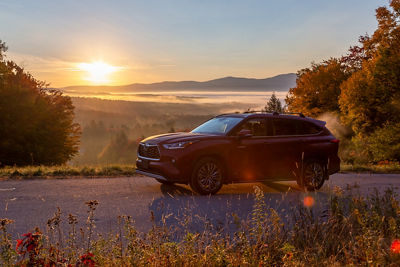 Toyota driving up Toll Road at Sunrise in Stowe
