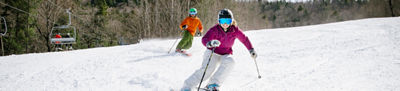 woman skiing in pink jacket
