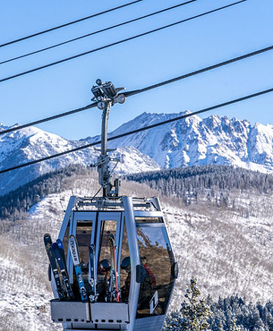 Skiers Enjoy Ride on Gondola One on a Bluebird Day in Vail, CO