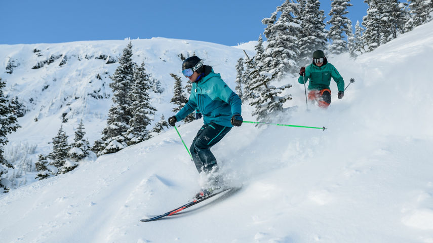 Adults skiing with instructor