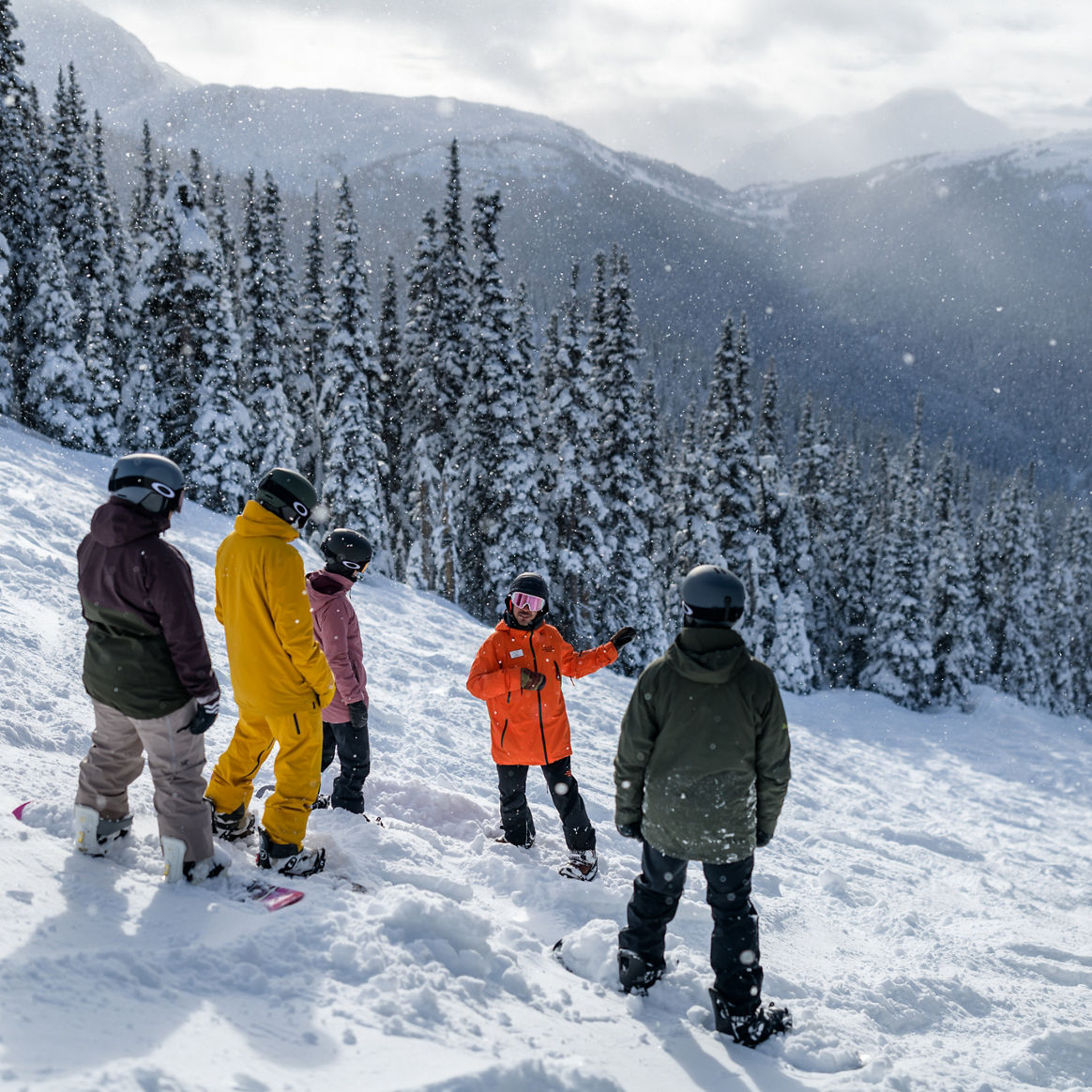 Adults snowboarding with instructor