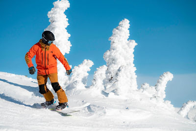 Snowboarder enjoys sunny day on Symphony, Whistler