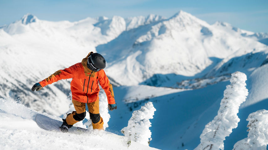 Snowboarder enjoys sunny day on Symphony, Whistler