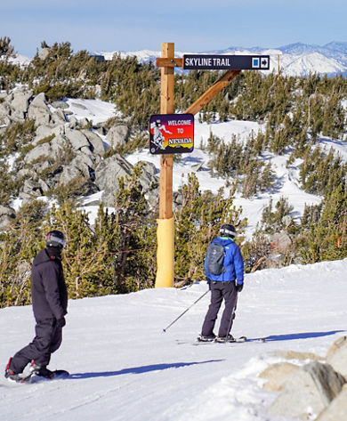 Skier and Snowboarder Crossing State Line into Nevada
