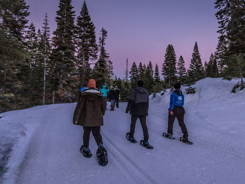 Group of Friends Twilight Snowshoeing at Northstar