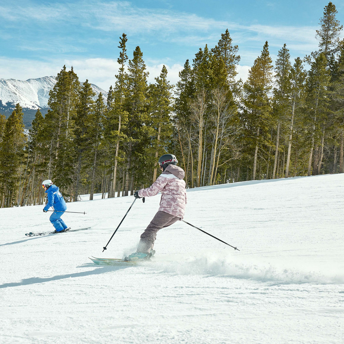 Adults skiing with an instructor