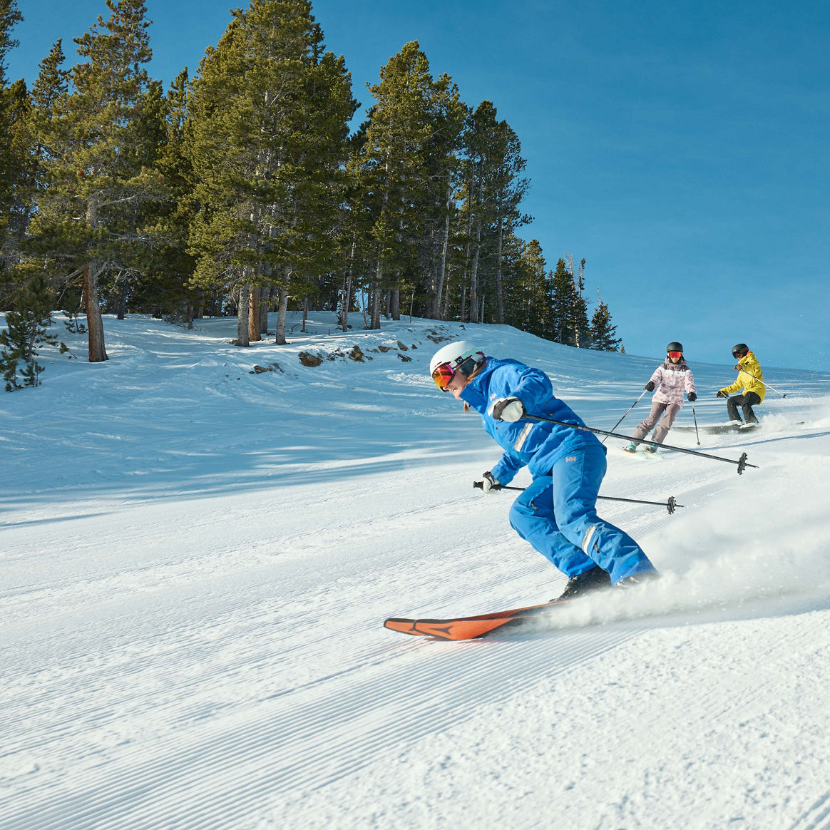 Adults skiing with an instructor