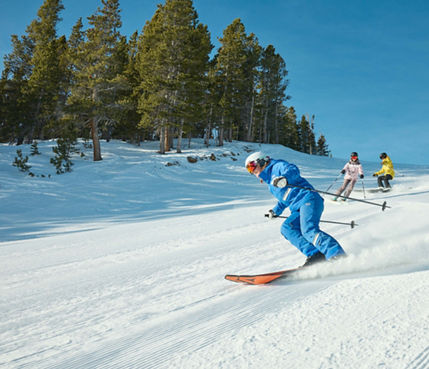 Adults skiing with an instructor