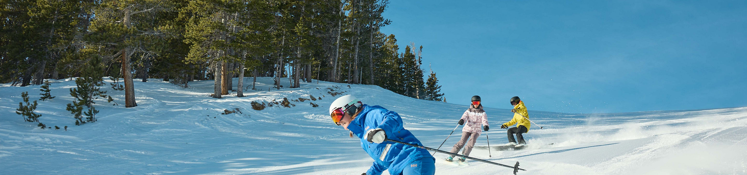 Adults skiing with an instructor