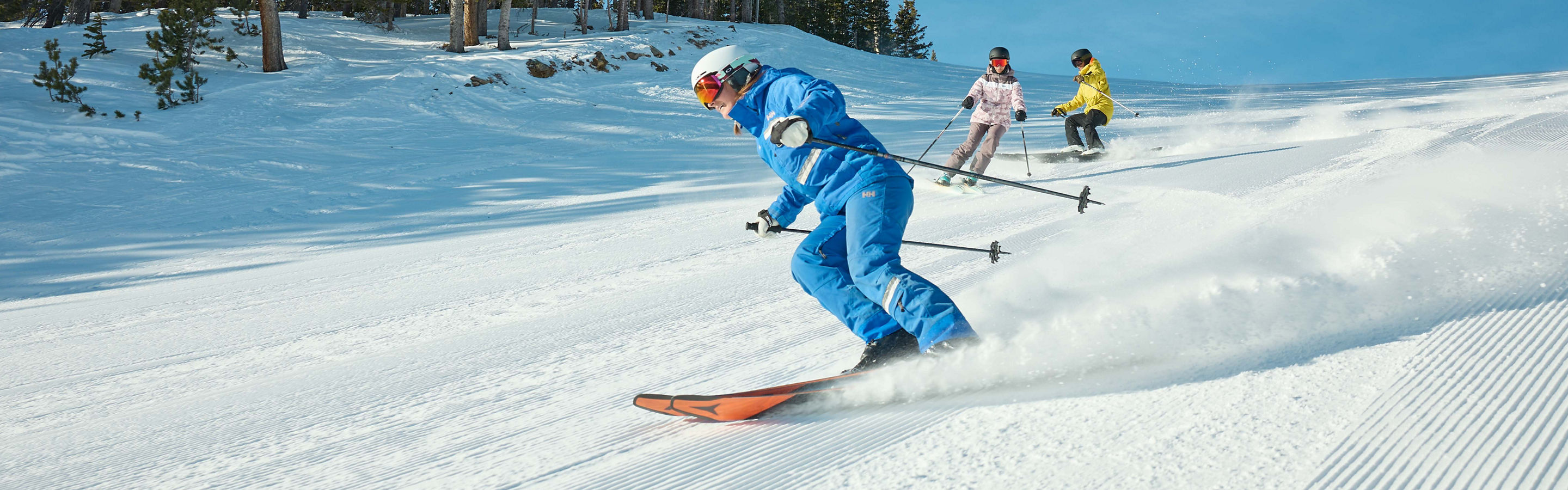 Adults skiing with an instructor