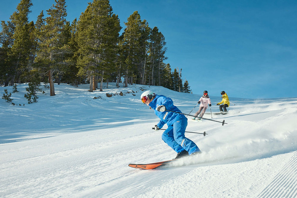 Adults skiing with an instructor