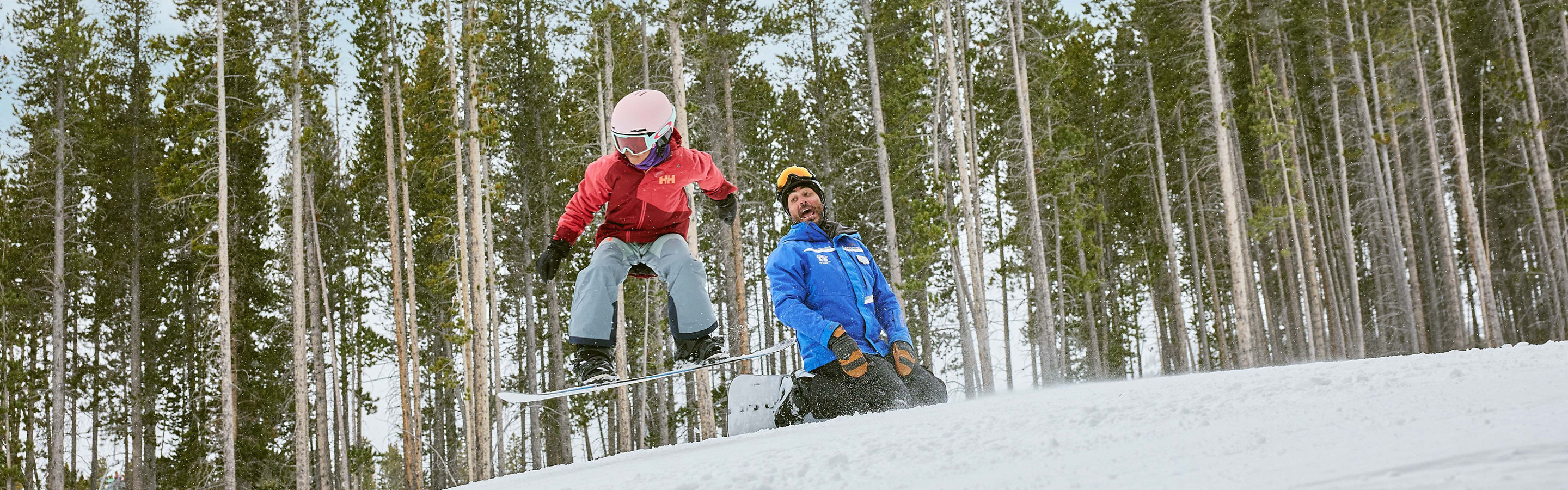 Older children snowboarding with an instructor (ATP)