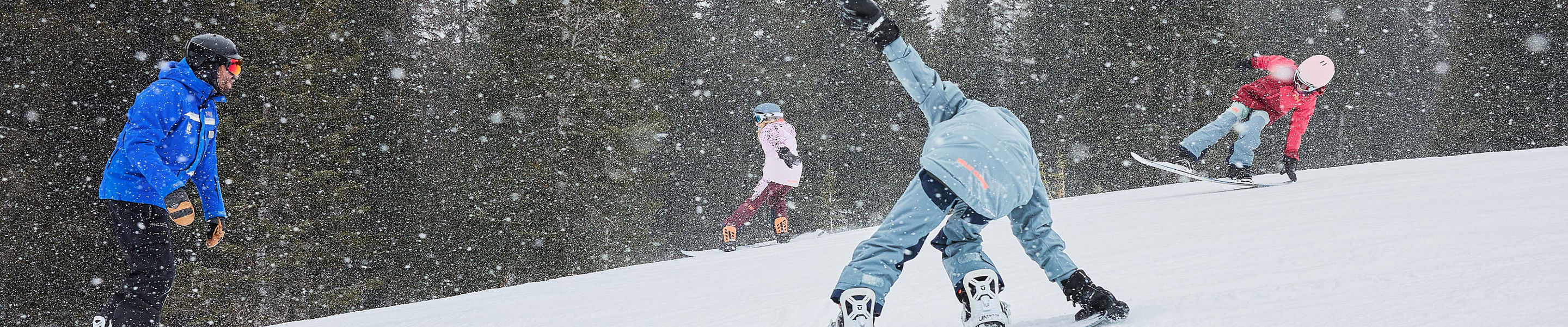 Older children snowboarding with an instructor (ATP)