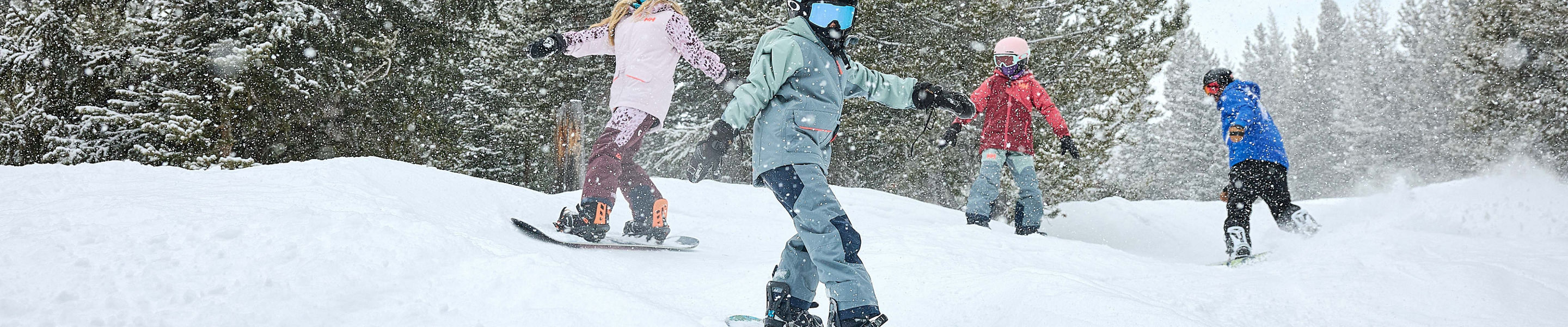 Older children snowboarding with an instructor (ATP)