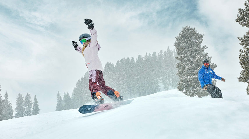 Older children snowboarding with an instructor (ATP)