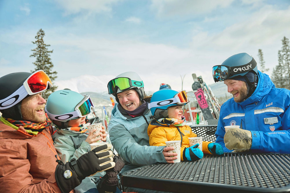 Family skiing with an instructor in a private lesson