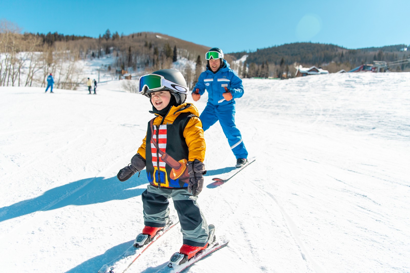 A young skier learning with an instructor at Haymeadow Park in Beaver Creek