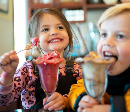 Young children eating ice cream at Ice Cream Parlour