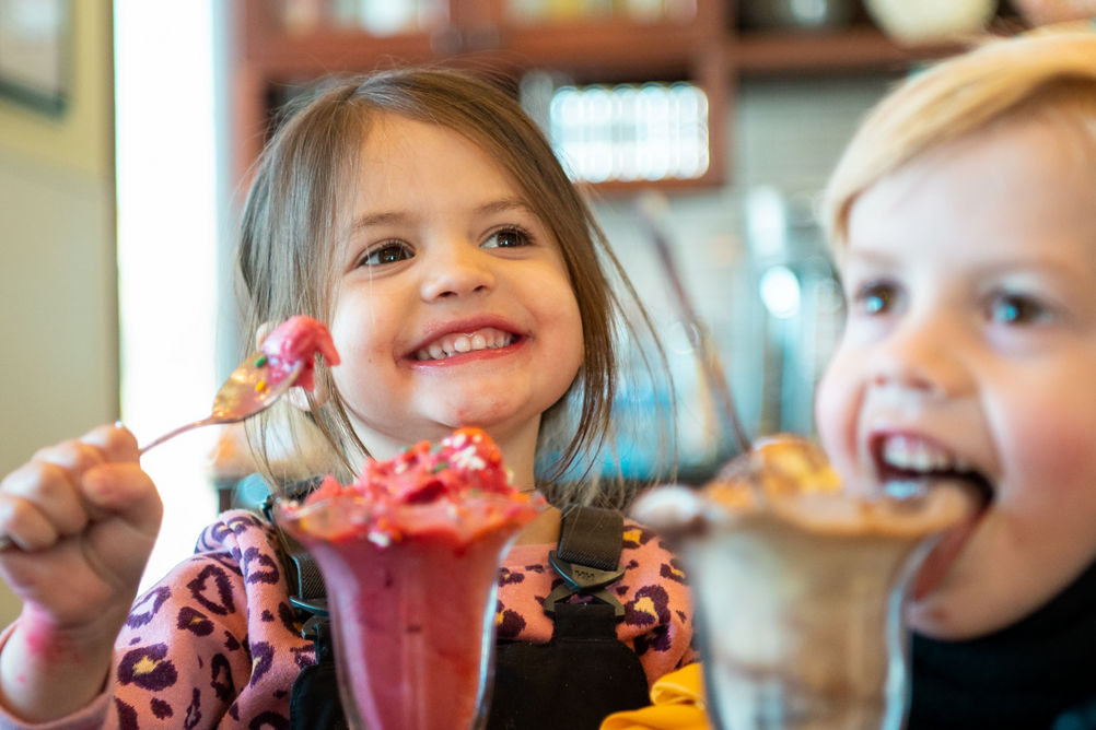 Young children eating ice cream at Ice Cream Parlour