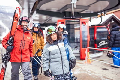 Family Carrying Skis to Gondola at Stowe