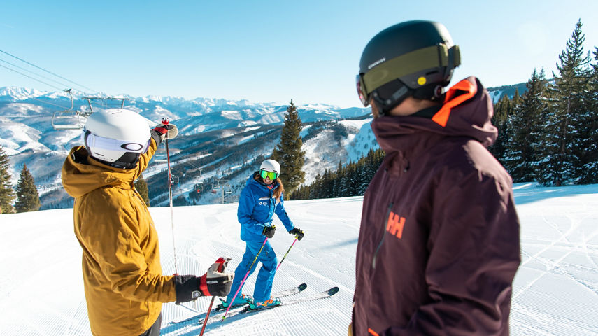 Adults skiing with an instructor