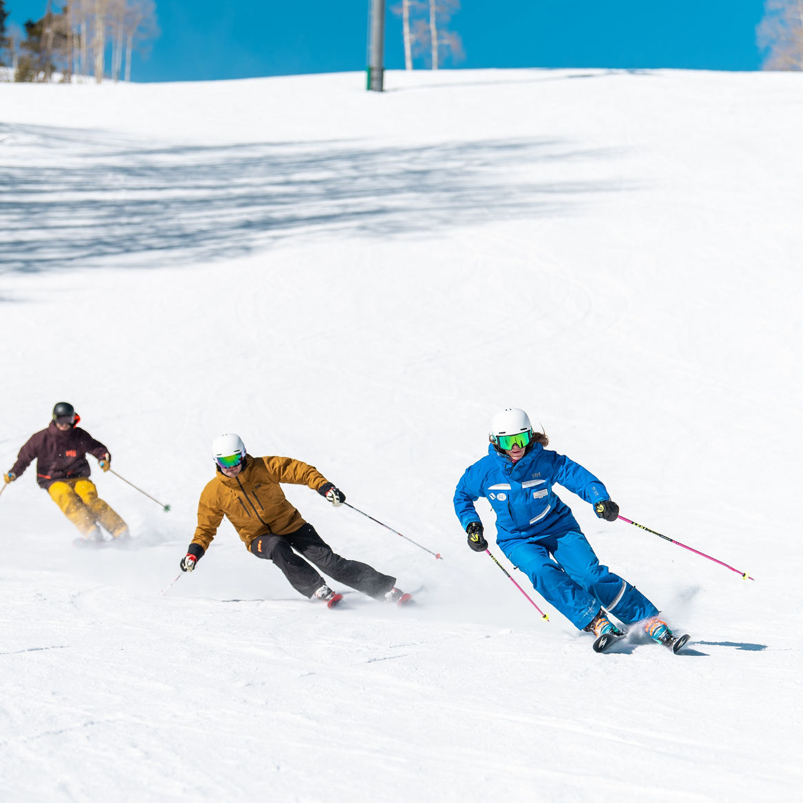 Adults skiing with an instructor