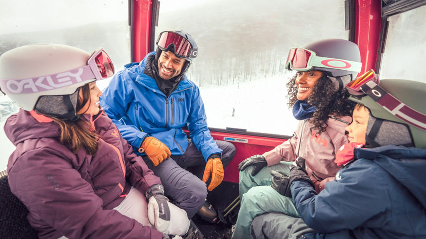 Family in Ski Gear Riding a Gondola at Stowe