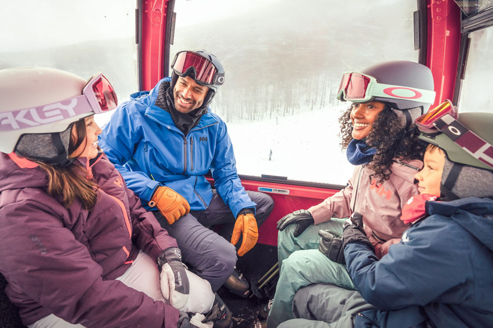 Family in Ski Gear Riding a Gondola at Stowe