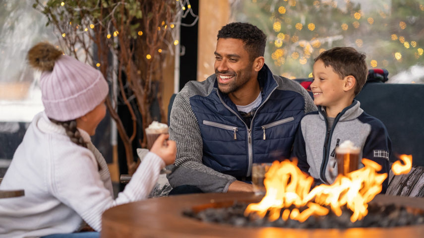 Family Drinking Hot Chocolate by a Fire at Stowe
