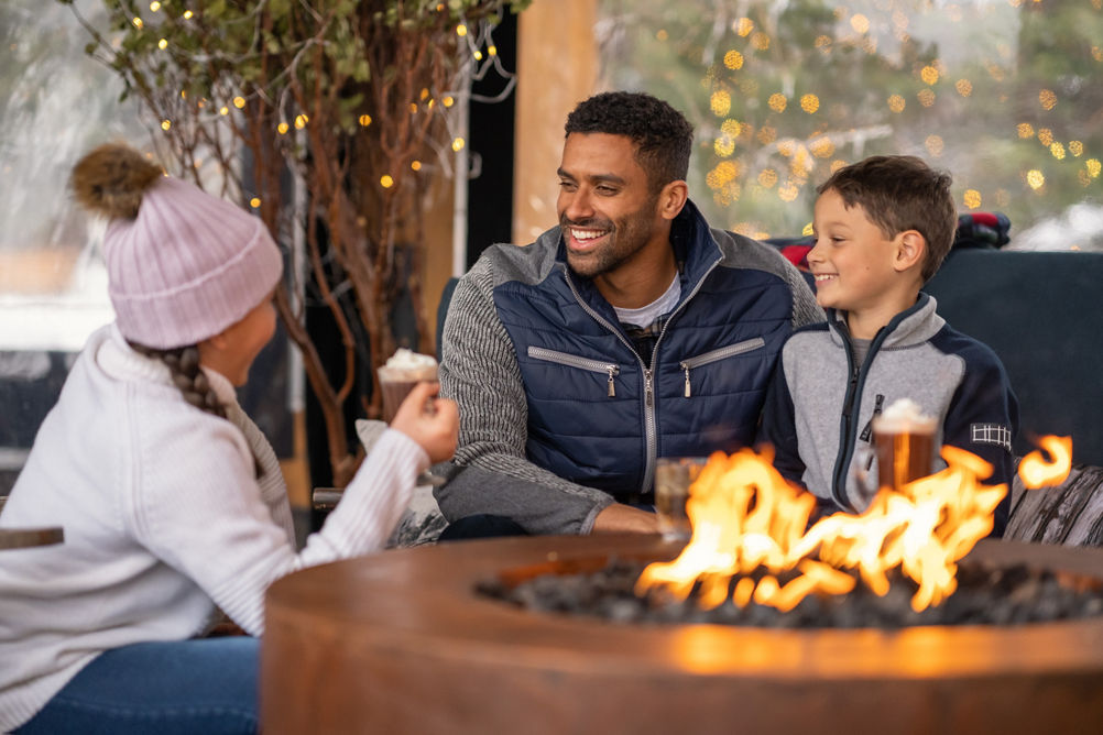 Family Drinking Hot Chocolate by a Fire at Stowe