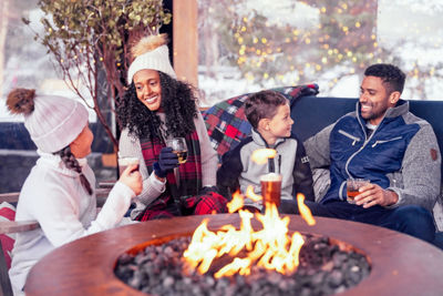 Family Enjoying Apres at Stowe Near a Fire