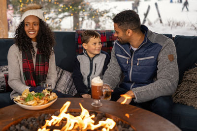 Family Enjoying Apres at Stowe Near a Fire