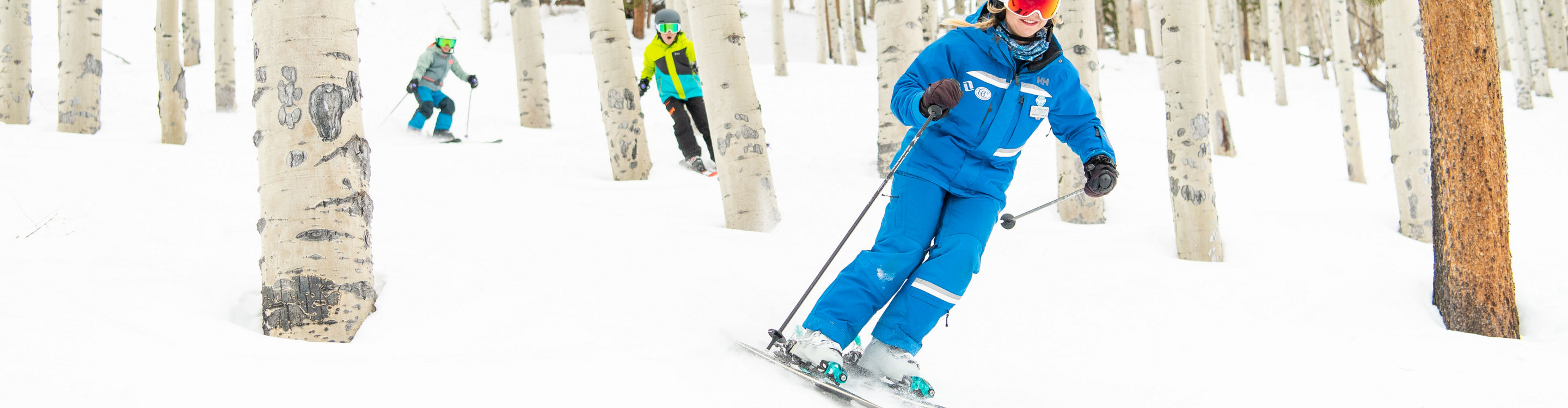 Older children skiing with an instructor