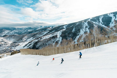 Older children snowboarding with an instructor