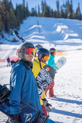 Friends gear up to go on mountain, walk at mid-mountain