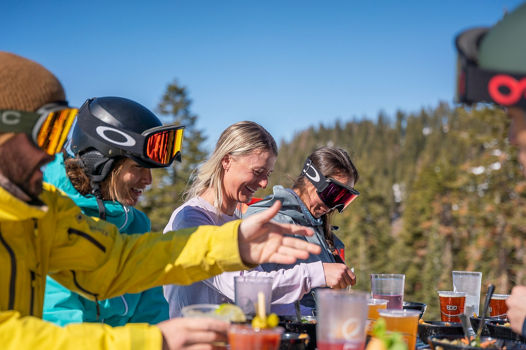 Skiers & riders enjoy lunch outside of zephyr lodge