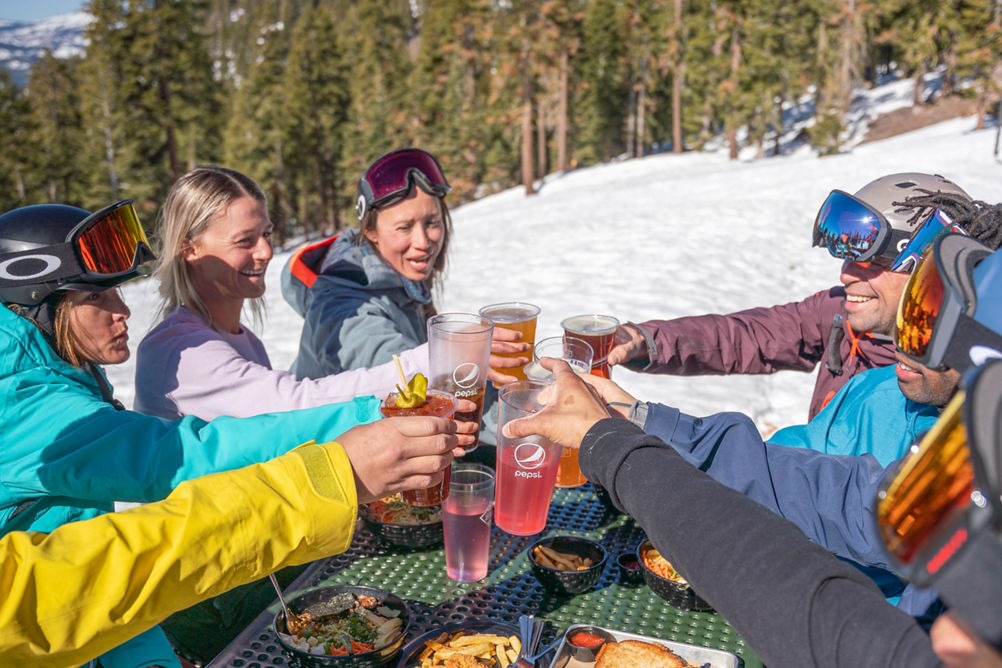 Skiers & riders enjoy lunch outside of zephyr lodge