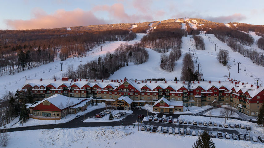 Grand Summit Resort Hotel at Mount Snow with Snowy Mountain and Clouds at Sunrise