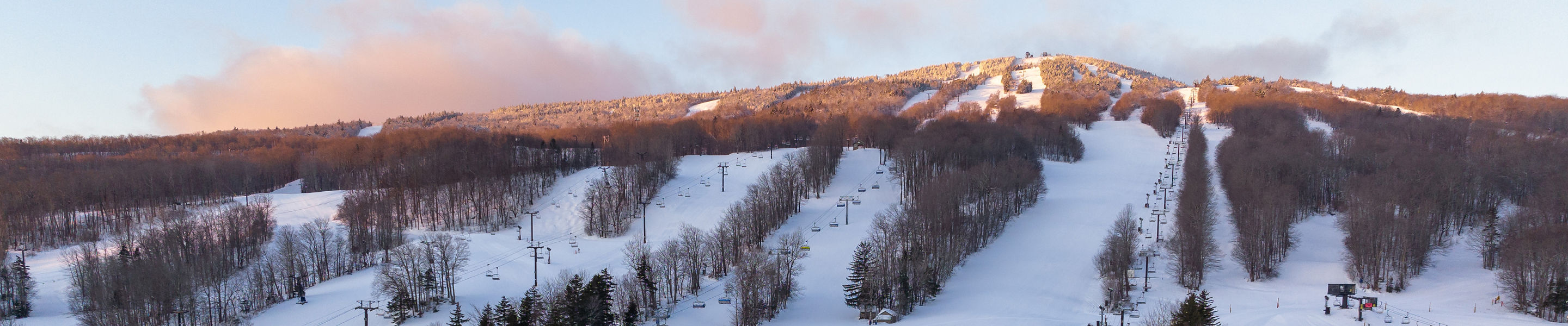 Clocktower and Bluebird Barn with Mount Snow in Background at Sunrise