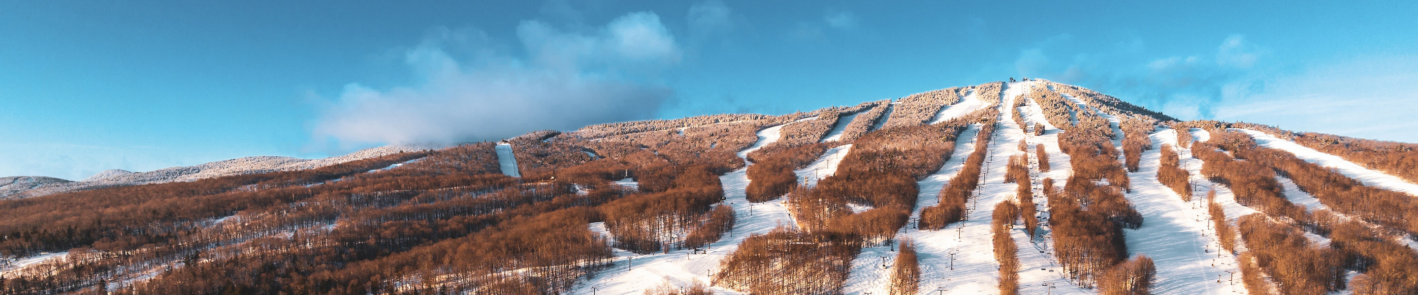 Full Mountain View of Mount Snow at Sunrise with Grand Summit, Bluebird Barn, Main Base Lodge, Clocktower