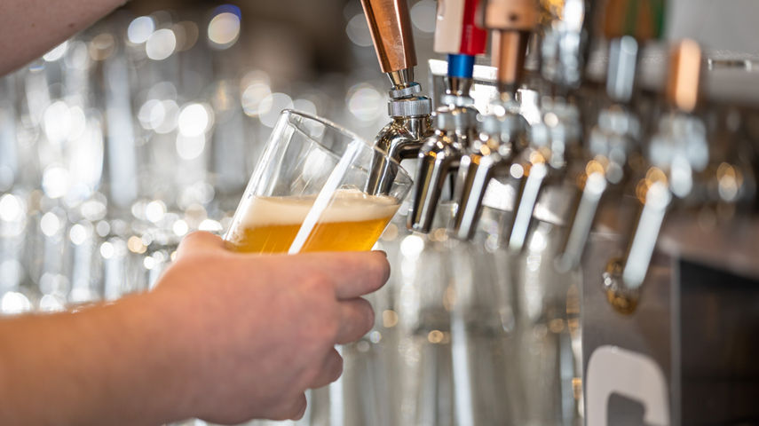 Taps Pouring Beer Into Pint Glass at High Timber Lounge in Carinthia Base Lodge at Mount Snow