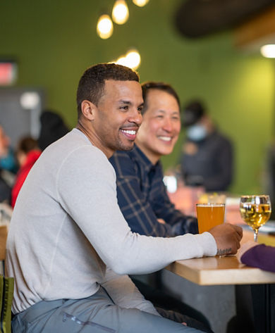 Friends Smile Over Drinks at High Timber Lounge in Carinthia Base Lodge at Mount Snow