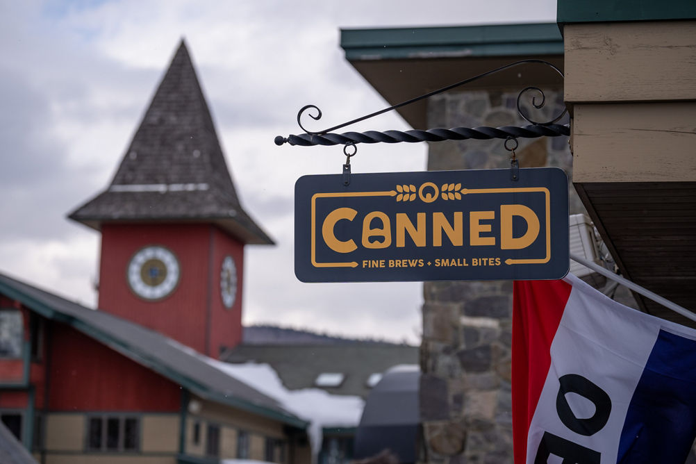 Canned Sign with part of Open Flag and Clocktower in Background at Mount Snow
