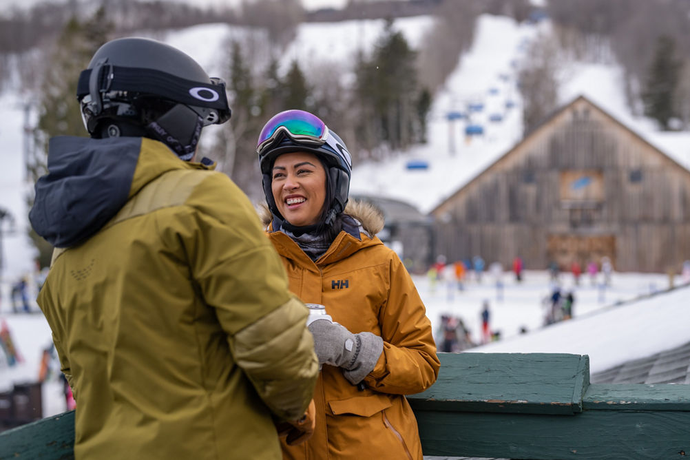 Couple Smiles on Station Tap Room Deck Overlooking Bluebird Barn at Mount Snow