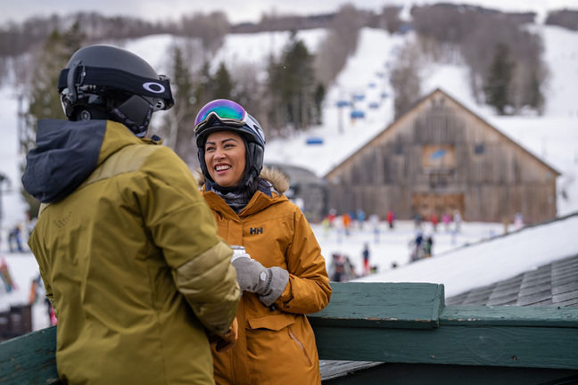 Couple Smiles on Station Tap Room Deck Overlooking Bluebird Barn at Mount Snow