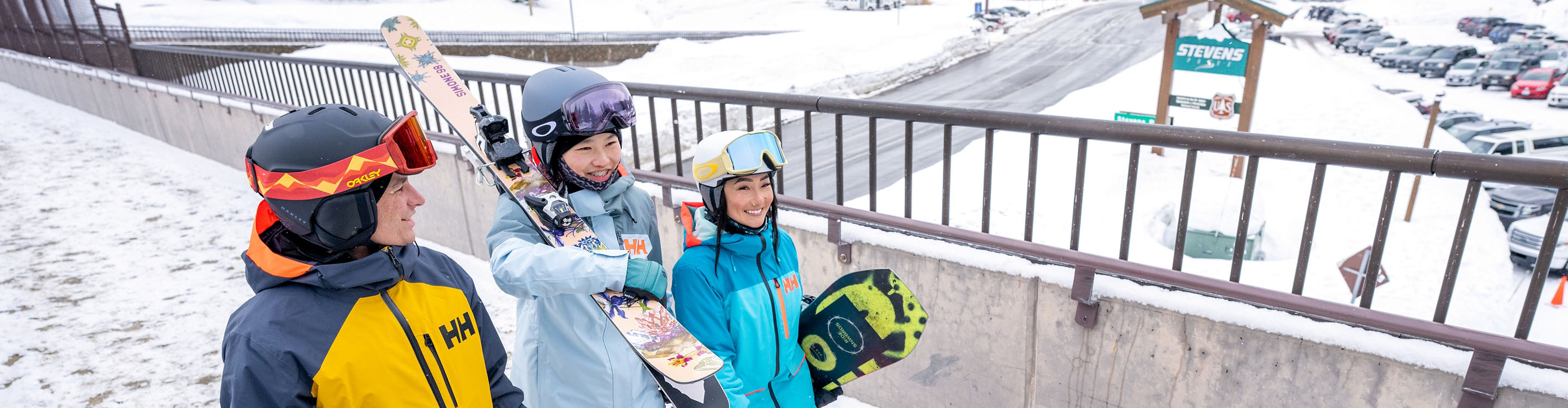 Group of 3 friends Conversing as They Walk Through the Base Area at Stevens Pass