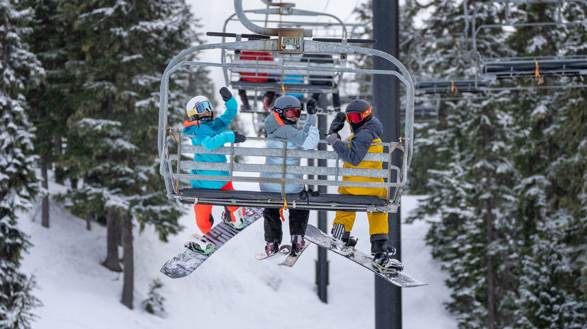 Group of 3 Friends Riding a Chairlift at Stevens Pass