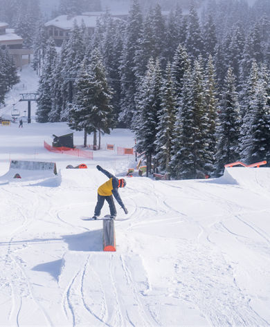 Snowboarder Hitting a Rail at the Terrain Park at Stevens Pass