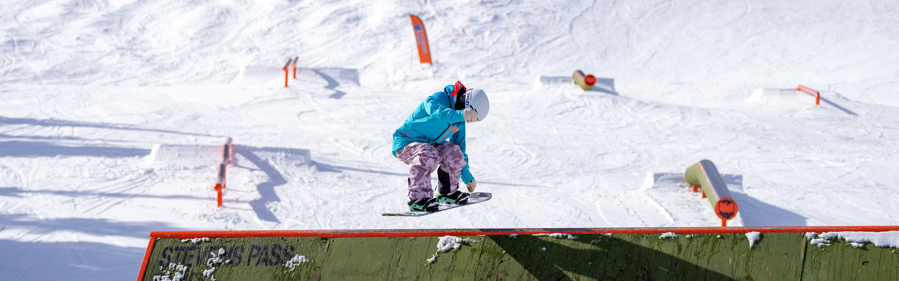 Snowboarder Jumping Off a Ramp at the Terrain Park at Stevens Pass