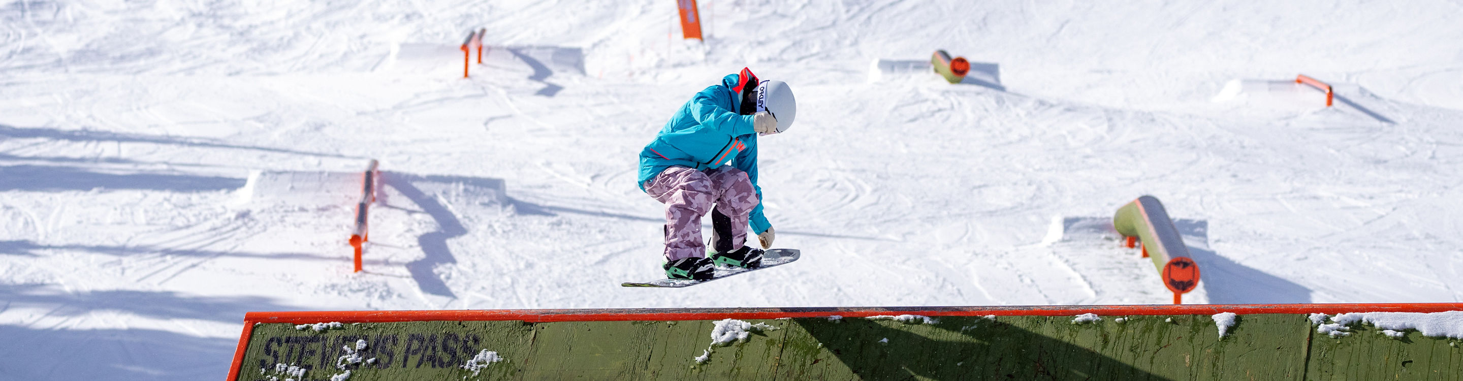 Snowboarder Jumping Off a Ramp at the Terrain Park at Stevens Pass